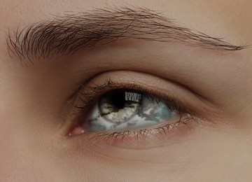 Image of Hypnosis. Hypnotic clouds in woman's eye, closeup