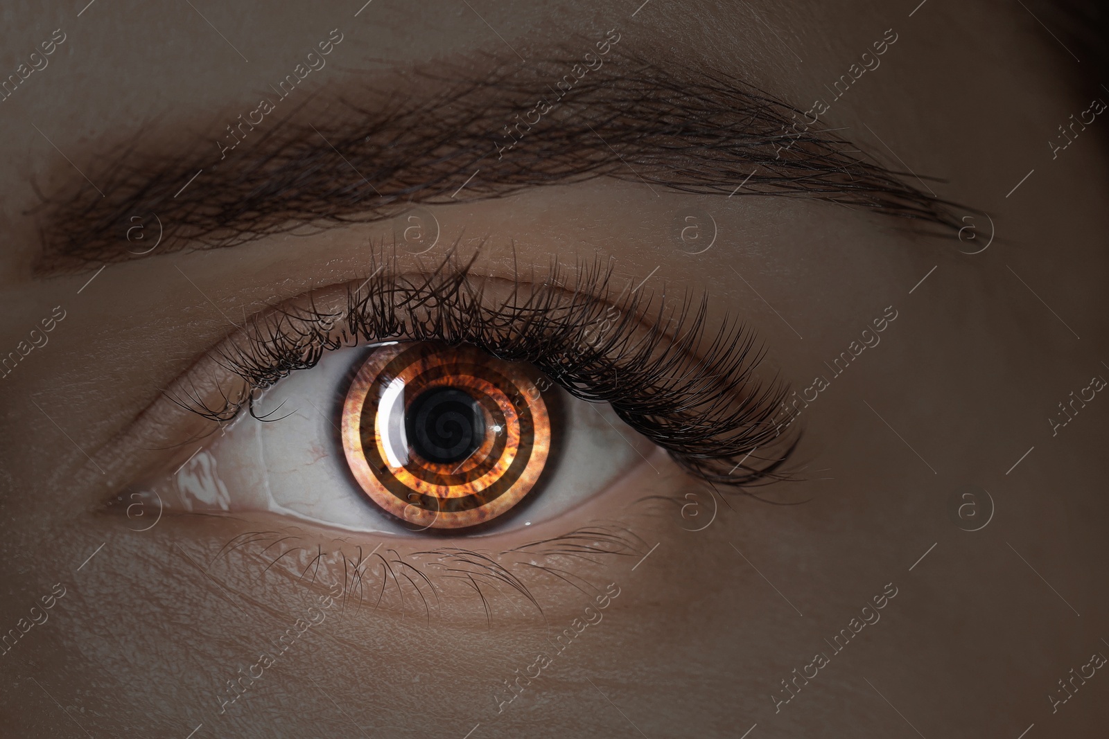 Image of Hypnosis. Hypnotic spiral in woman's eye, closeup