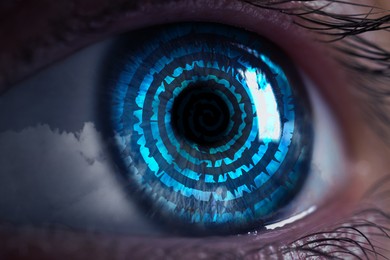 Image of Hypnosis. Hypnotic spiral and clouds in woman's eye, closeup