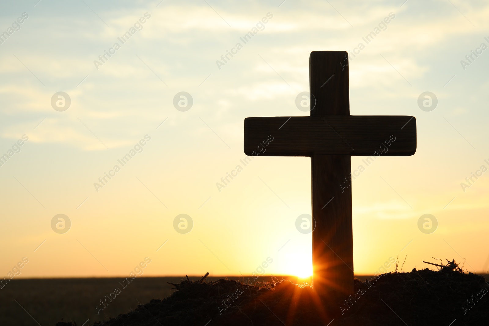 Photo of Silhouette of Christian cross outdoors at sunrise, space for text. Religion concept