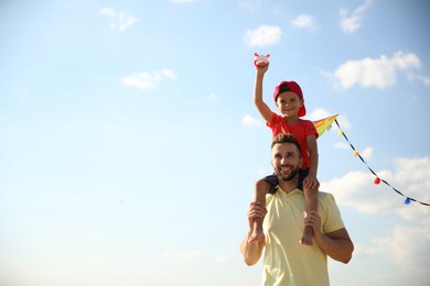 Photo of Happy father and his child playing with kite on sunny day. Spending time in nature