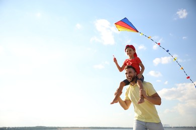 Photo of Happy father and his child playing with kite on sunny day. Spending time in nature