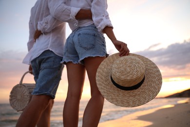 Photo of Lovely couple walking on beach at sunset, closeup