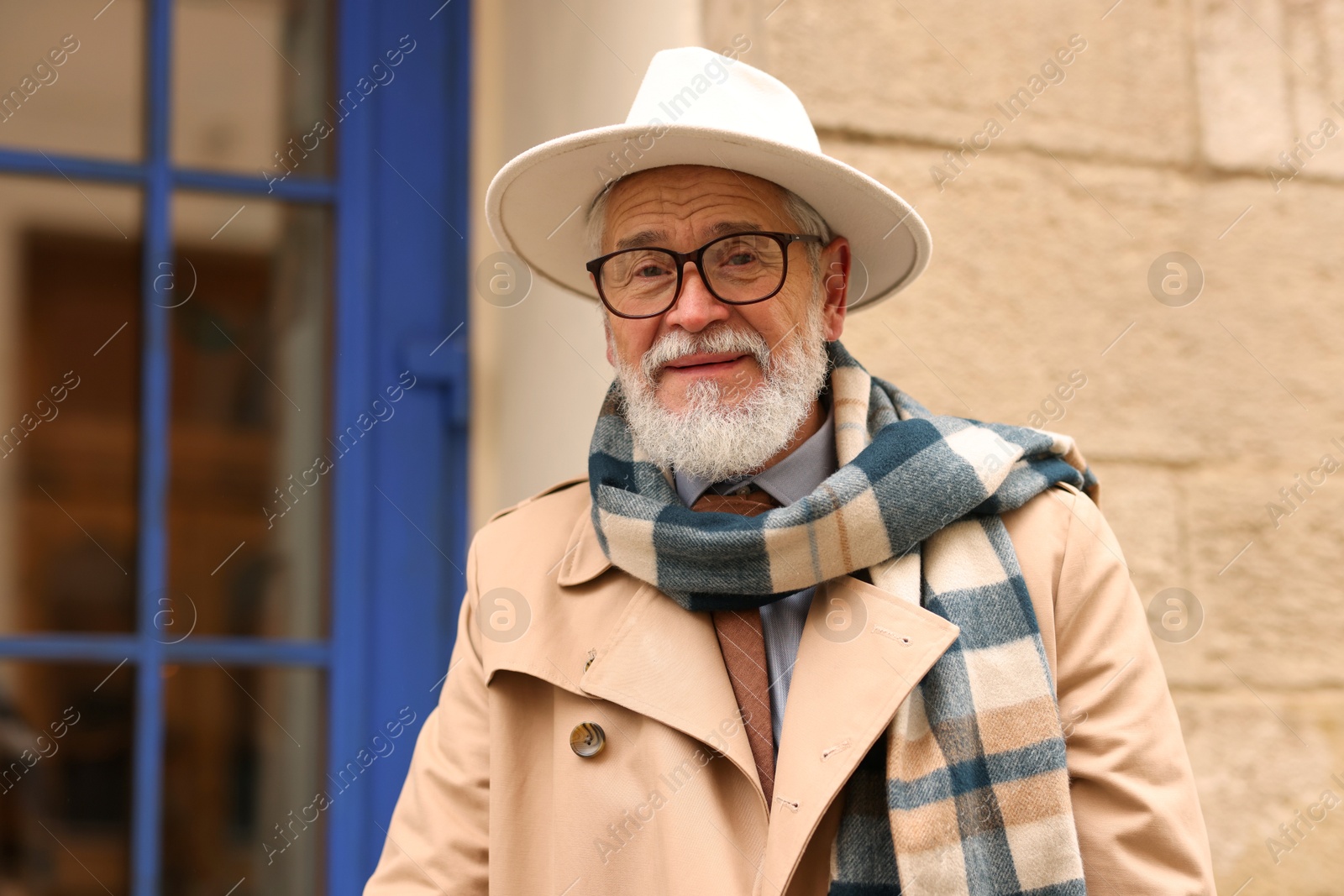 Photo of Stylish bearded senior man on city street