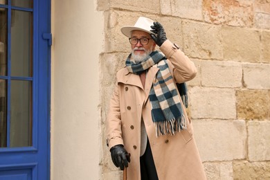 Photo of Stylish bearded senior man on city street