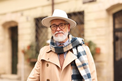 Photo of Stylish bearded senior man on city street