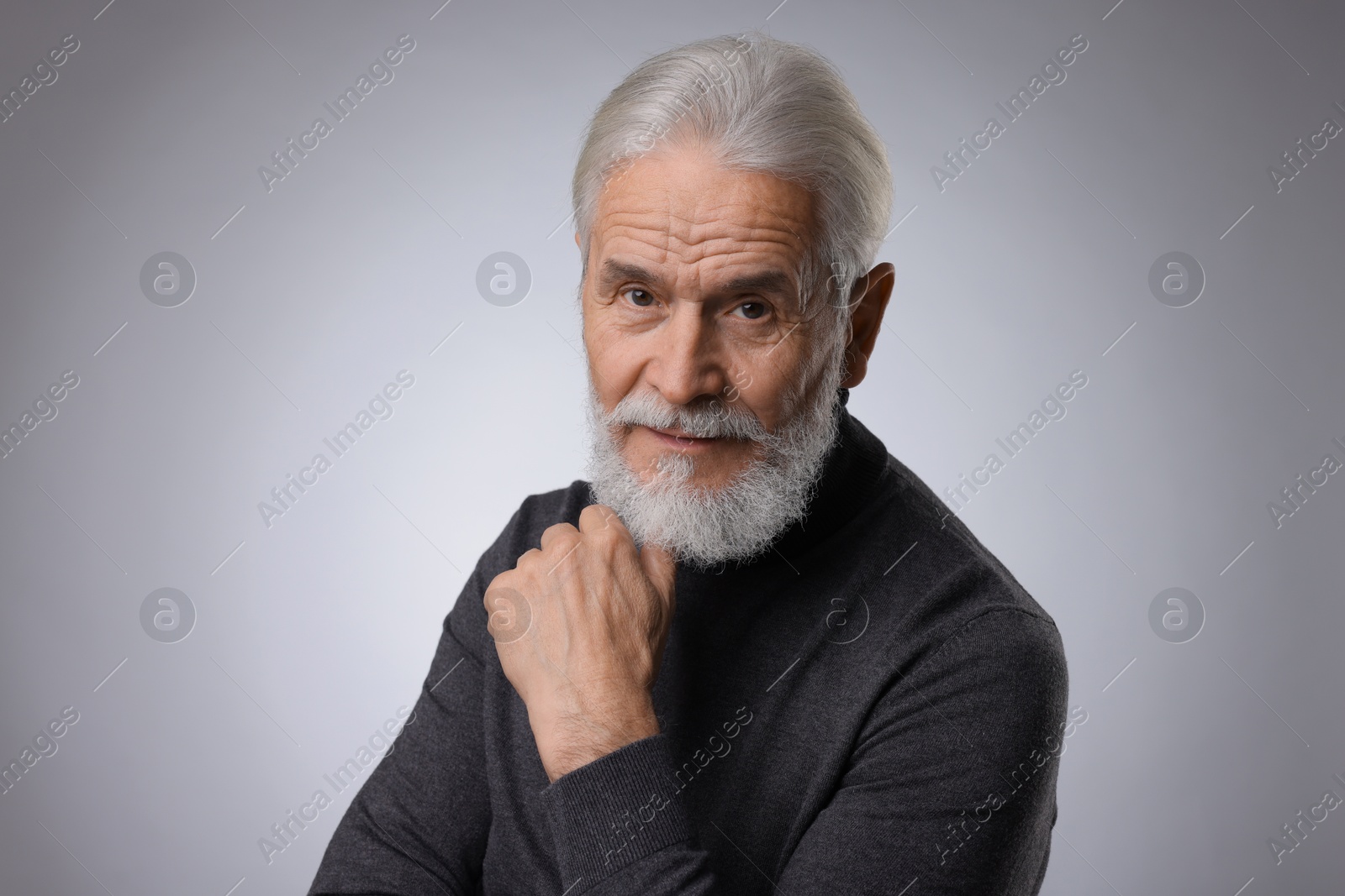 Photo of Portrait of confident senior man with silver beard on light grey background