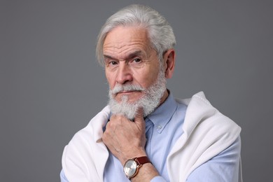 Photo of Portrait of stylish bearded man on grey background