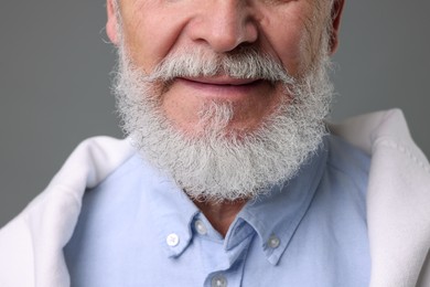 Photo of Senior man with gray beard on grey background, closeup