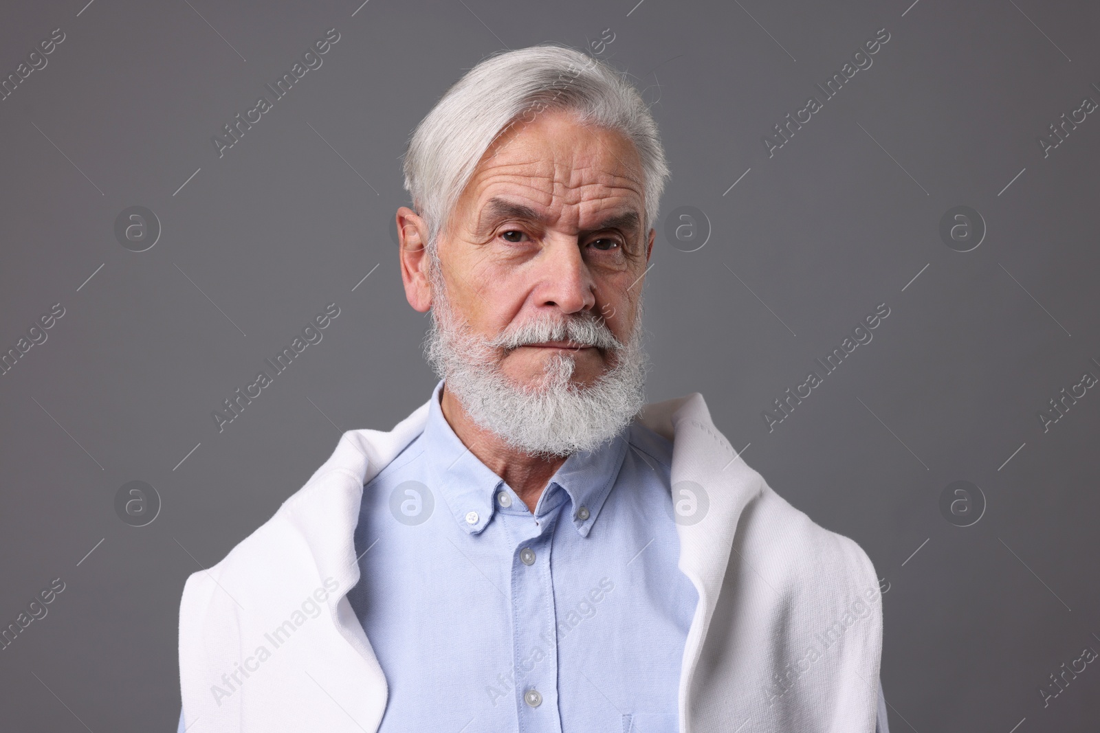 Photo of Portrait of stylish bearded man on grey background