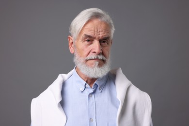 Portrait of stylish bearded man on grey background