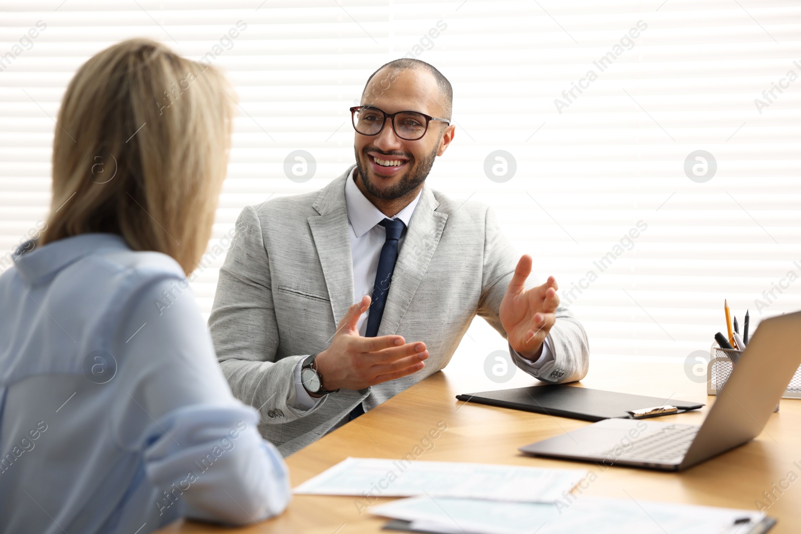 Photo of Coworkers working together at table in office