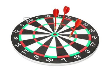 Photo of Dart board with red arrows hitting target isolated on white