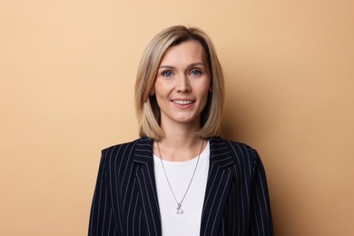 Photo of Portrait of businesswoman in jacket on beige background