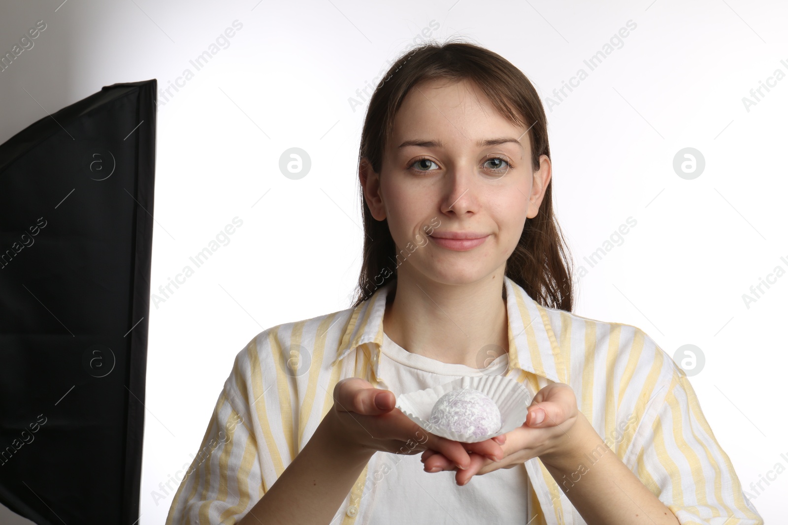 Photo of Beautiful woman with tasty mochi on white background