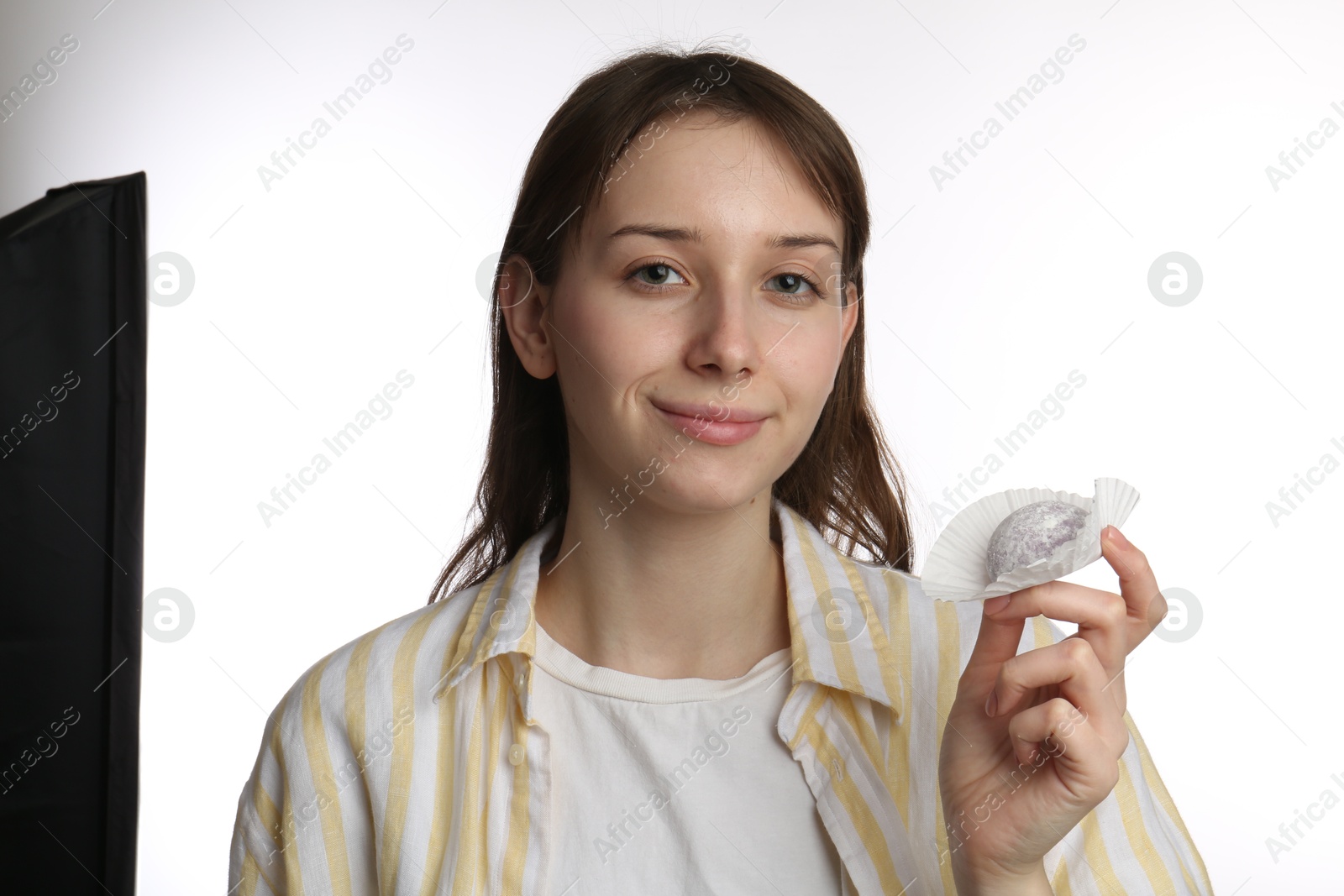 Photo of Beautiful woman with tasty mochi on white background