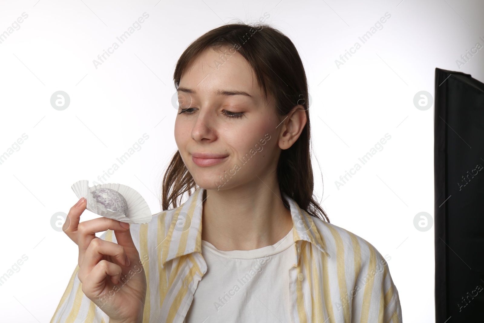 Photo of Beautiful woman with tasty mochi on white background