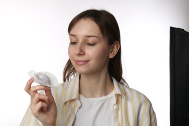 Photo of Beautiful woman with tasty mochi on white background