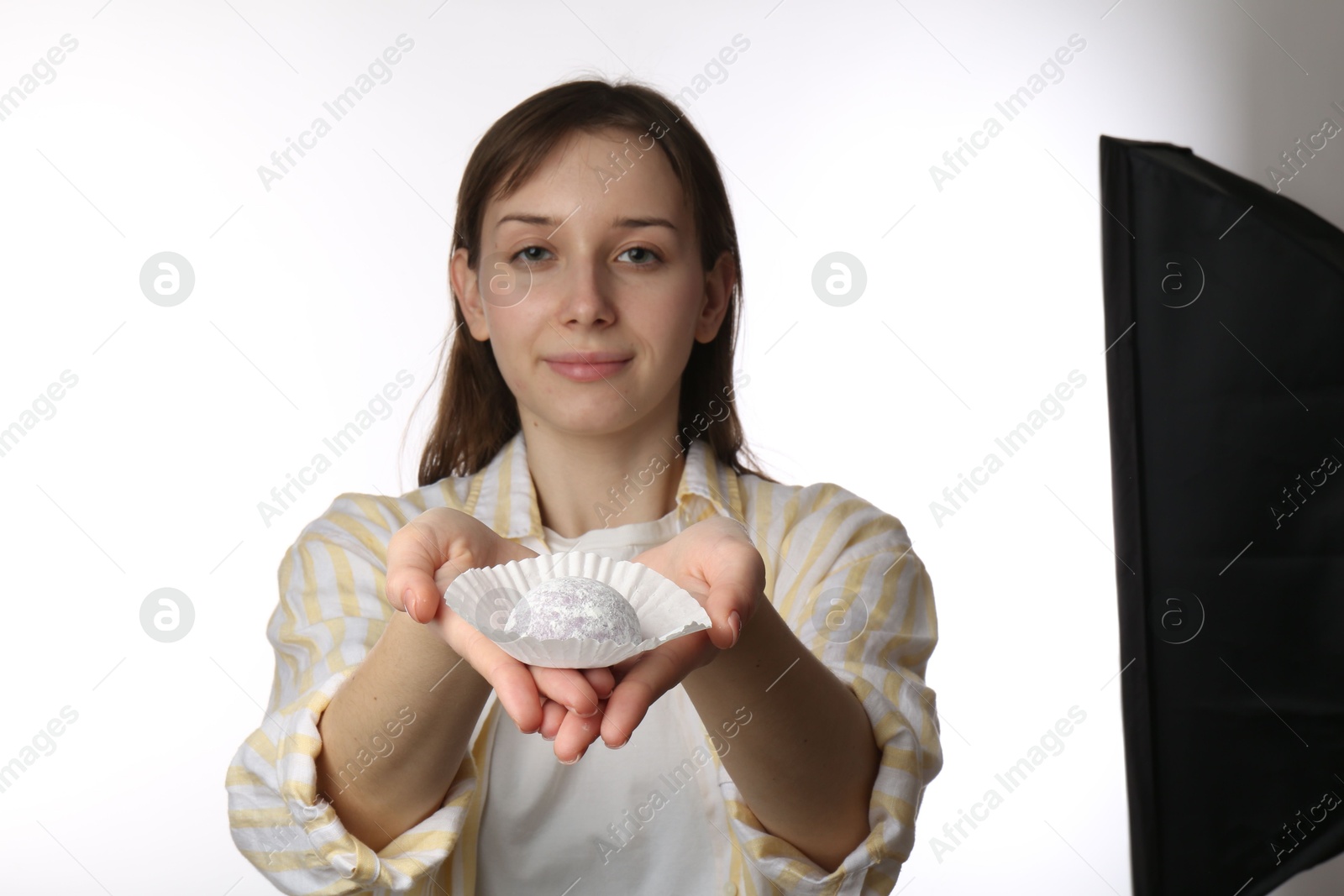 Photo of Beautiful woman with tasty mochi on white background