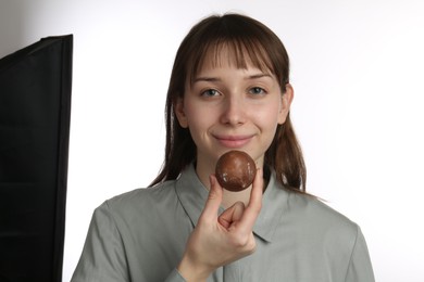 Photo of Beautiful woman with tasty mochi on white background