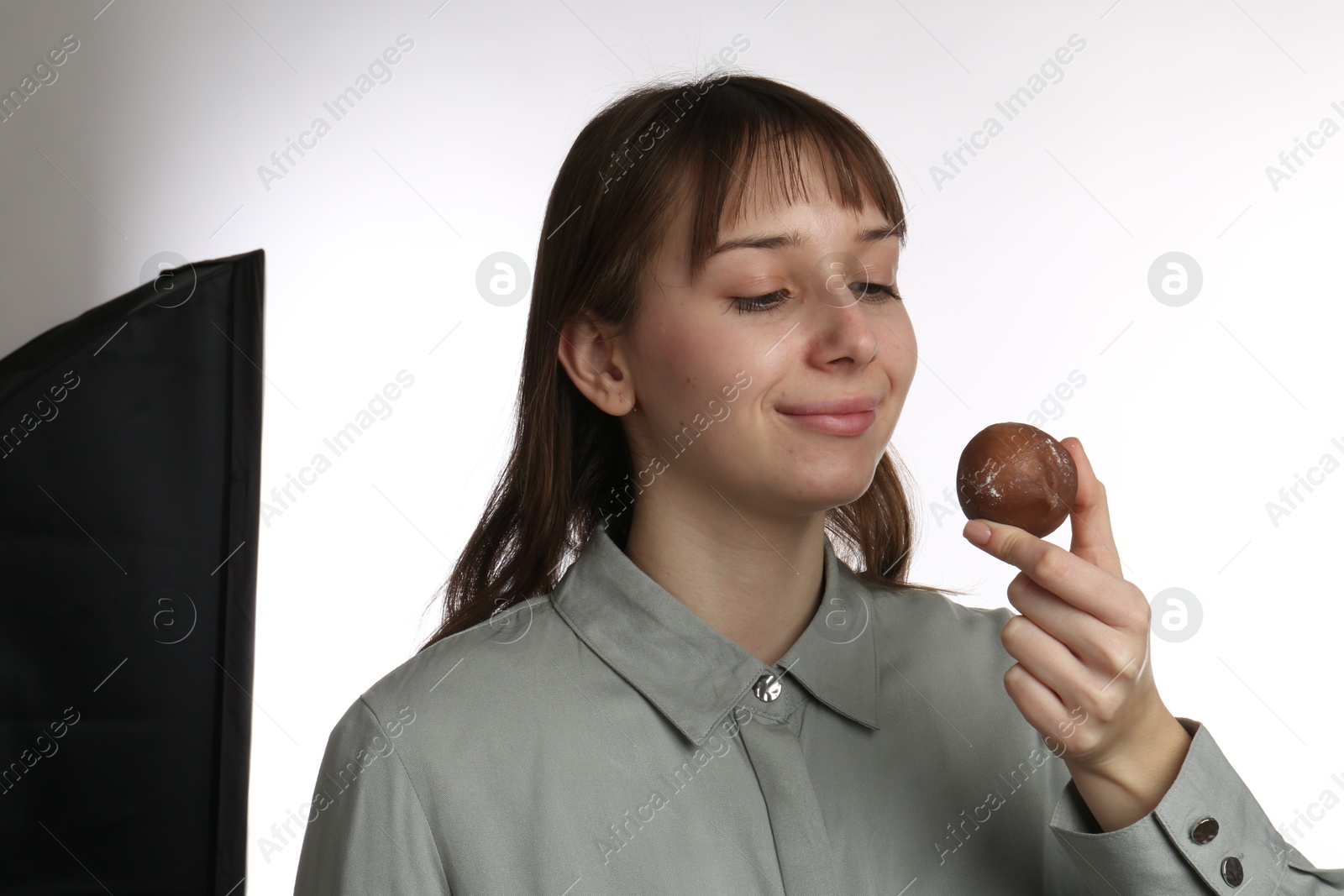 Photo of Beautiful woman with tasty mochi on white background