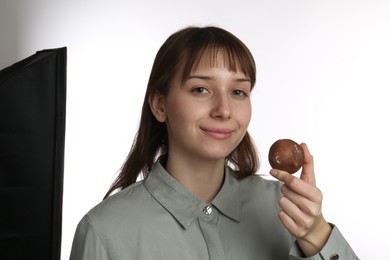 Photo of Beautiful woman with tasty mochi on white background