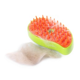 Photo of Grooming brush and pile of pet's hair isolated on white