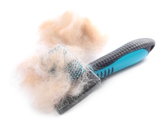 Photo of Grooming brush and pile of pet's hair isolated on white