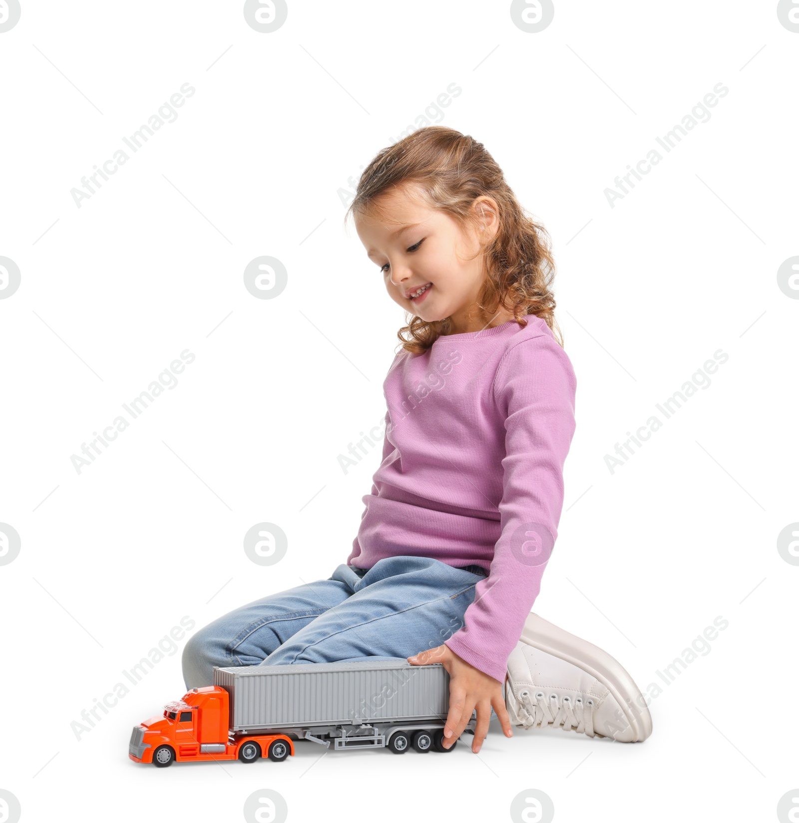 Photo of Little girl playing with toy car on white background