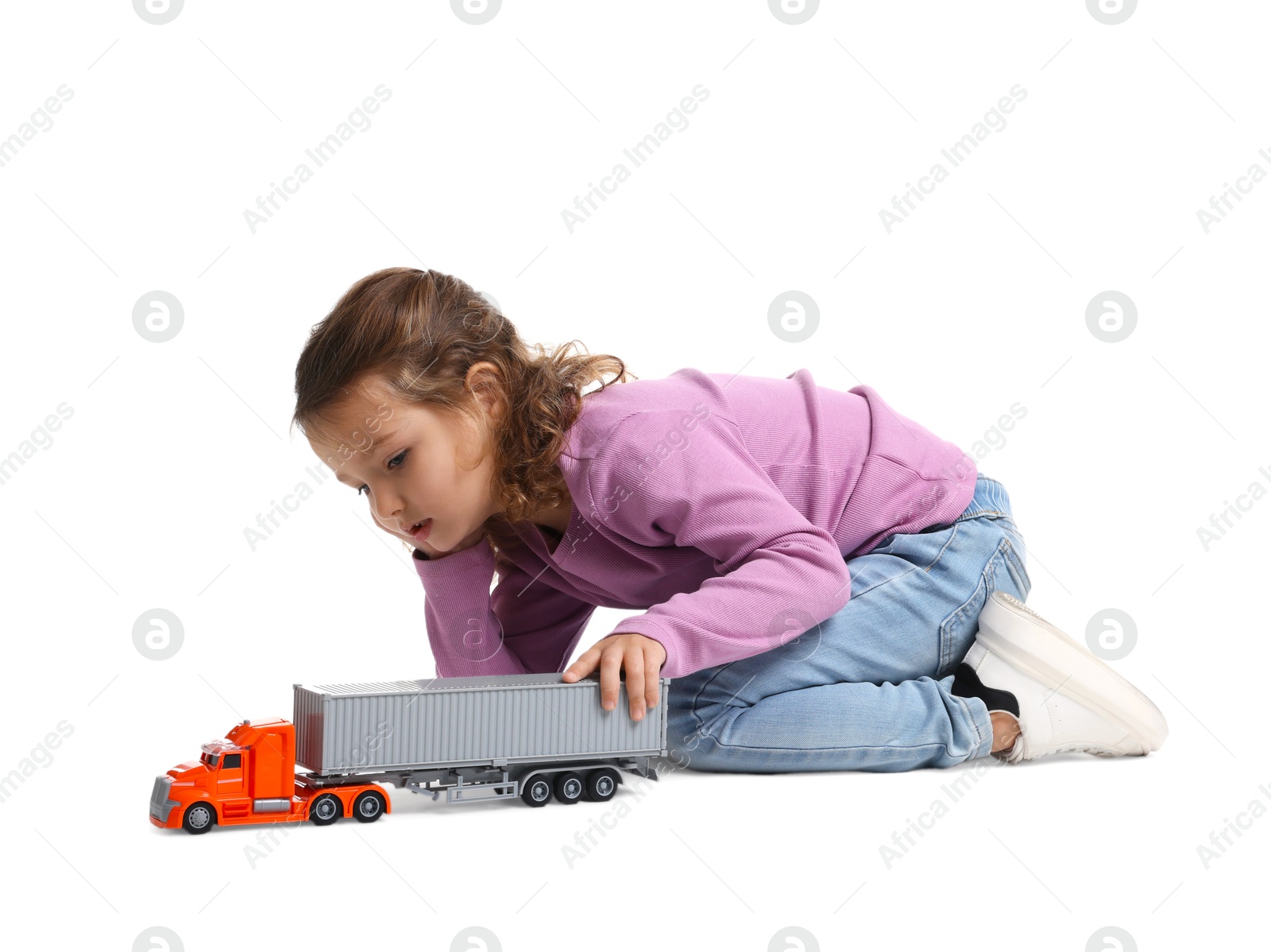 Photo of Little girl playing with toy car on white background