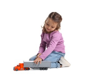 Photo of Little girl playing with toy car on white background