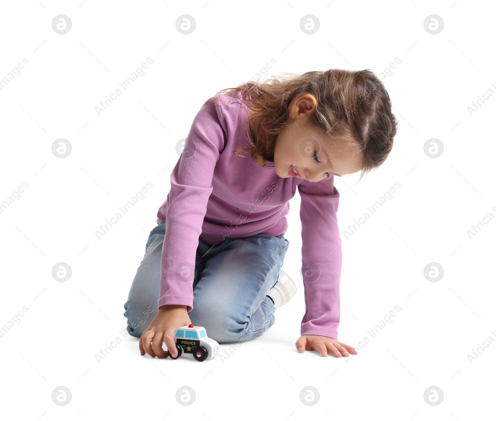 Photo of Little girl playing with toy car on white background