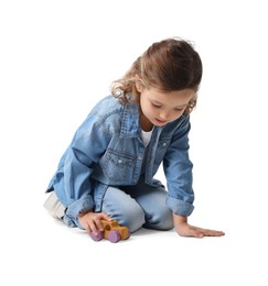 Photo of Little girl playing with toy car on white background