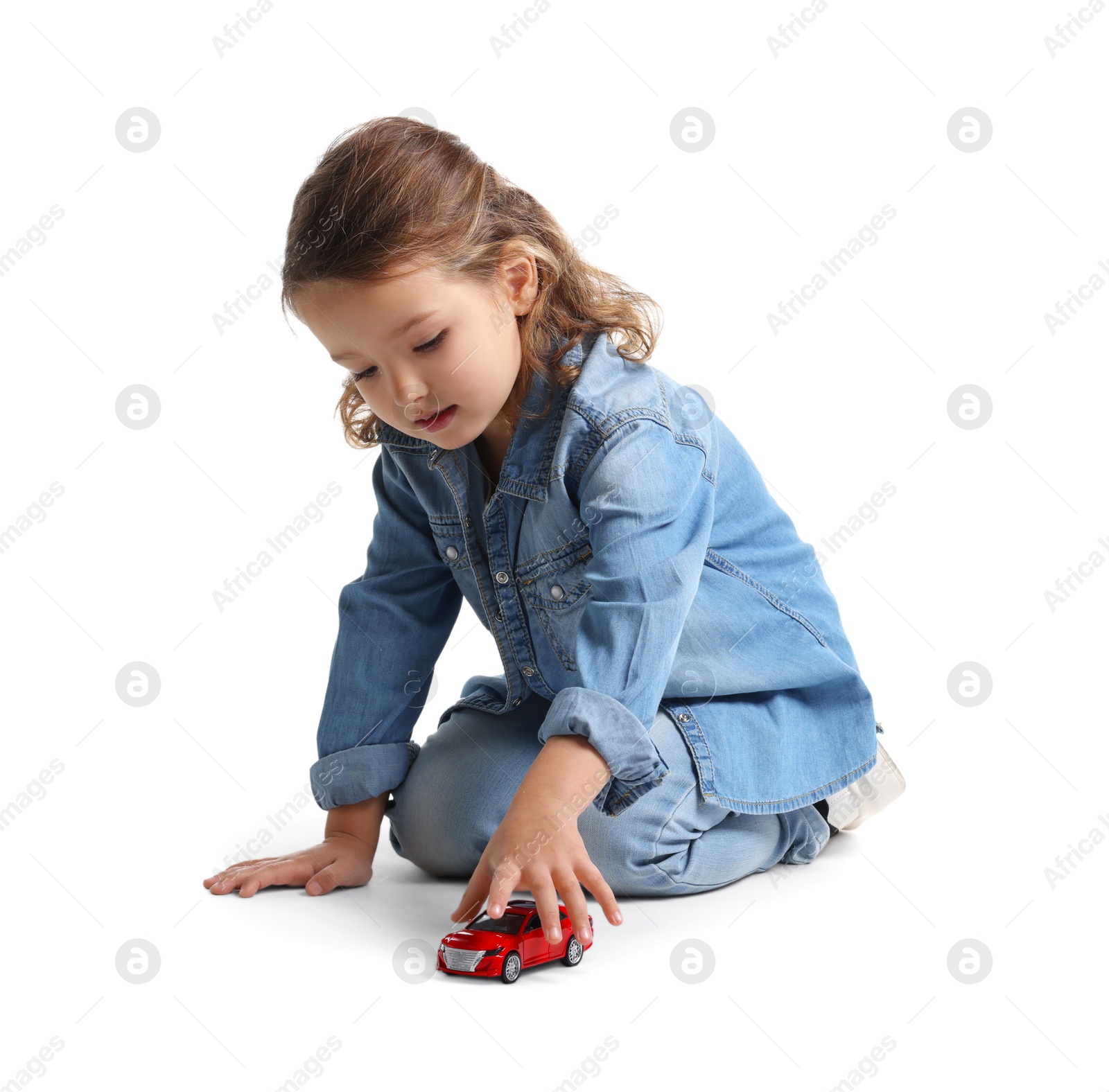 Photo of Little girl playing with toy car on white background