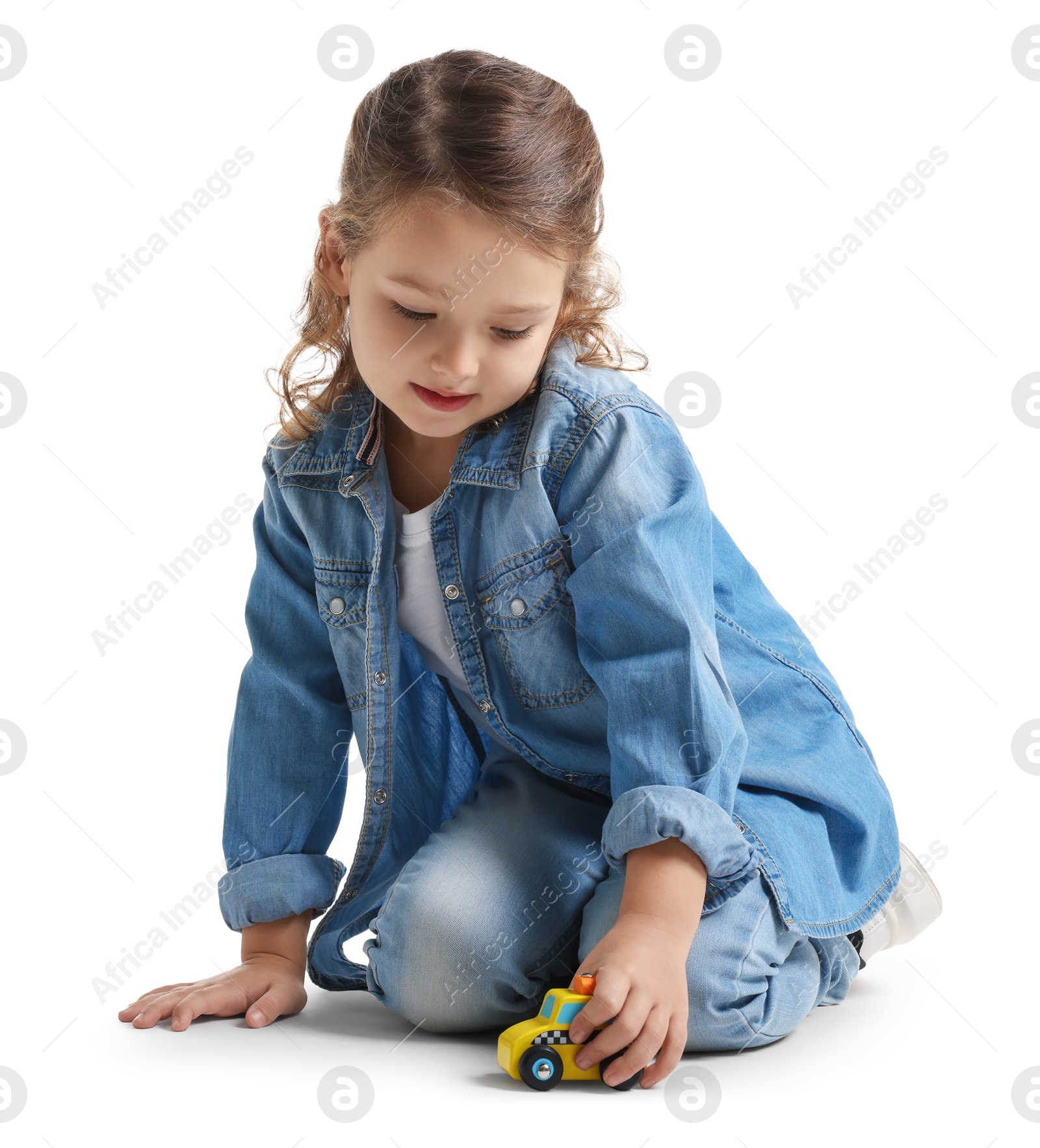 Photo of Little girl playing with toy car on white background