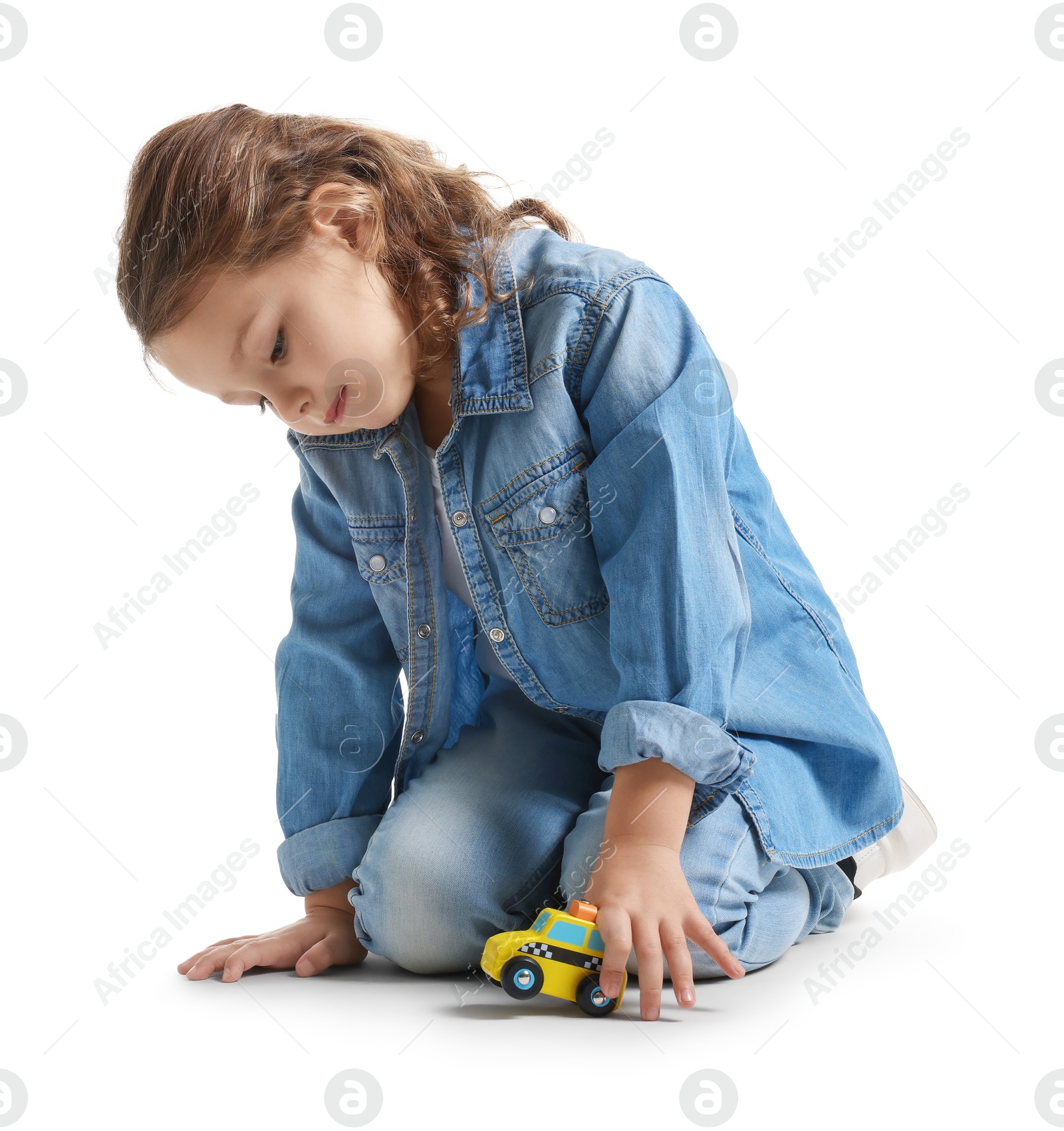 Photo of Little girl playing with toy car on white background