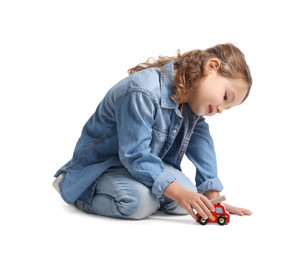 Little girl playing with toy car on white background