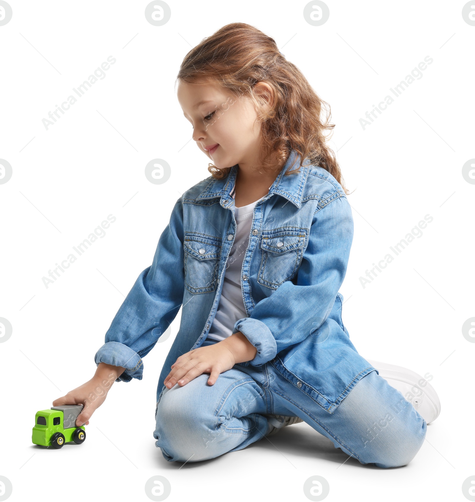 Photo of Little girl playing with toy car on white background