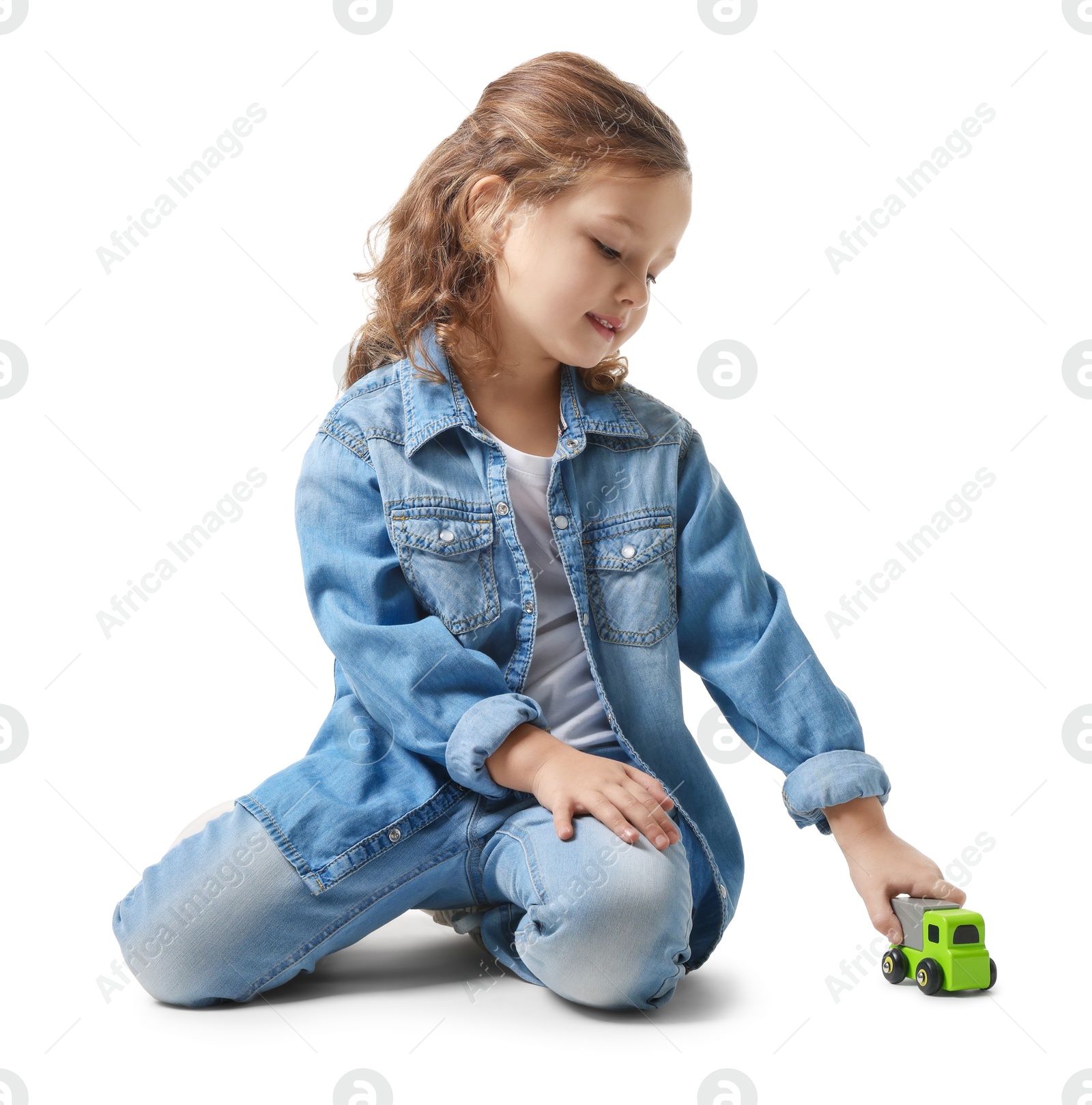 Photo of Little girl playing with toy car on white background