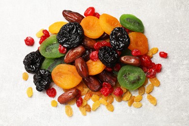 Photo of Mix of different dried fruits on light grey table, top view