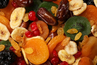 Photo of Mix of different dried fruits as background, top view