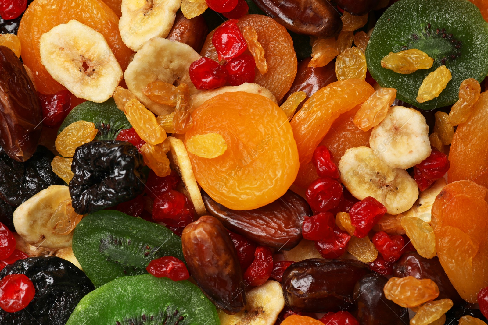 Photo of Mix of different dried fruits as background, top view