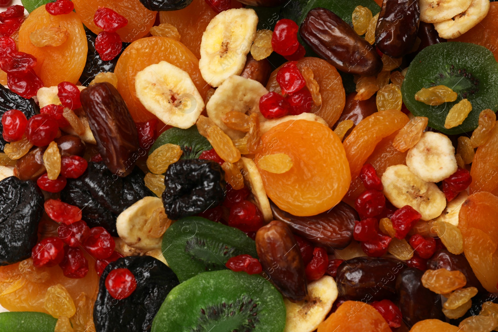 Photo of Mix of different dried fruits as background, top view