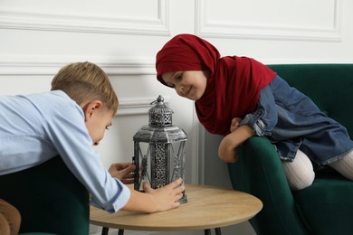 Photo of Muslim sister and brother spending time together at home