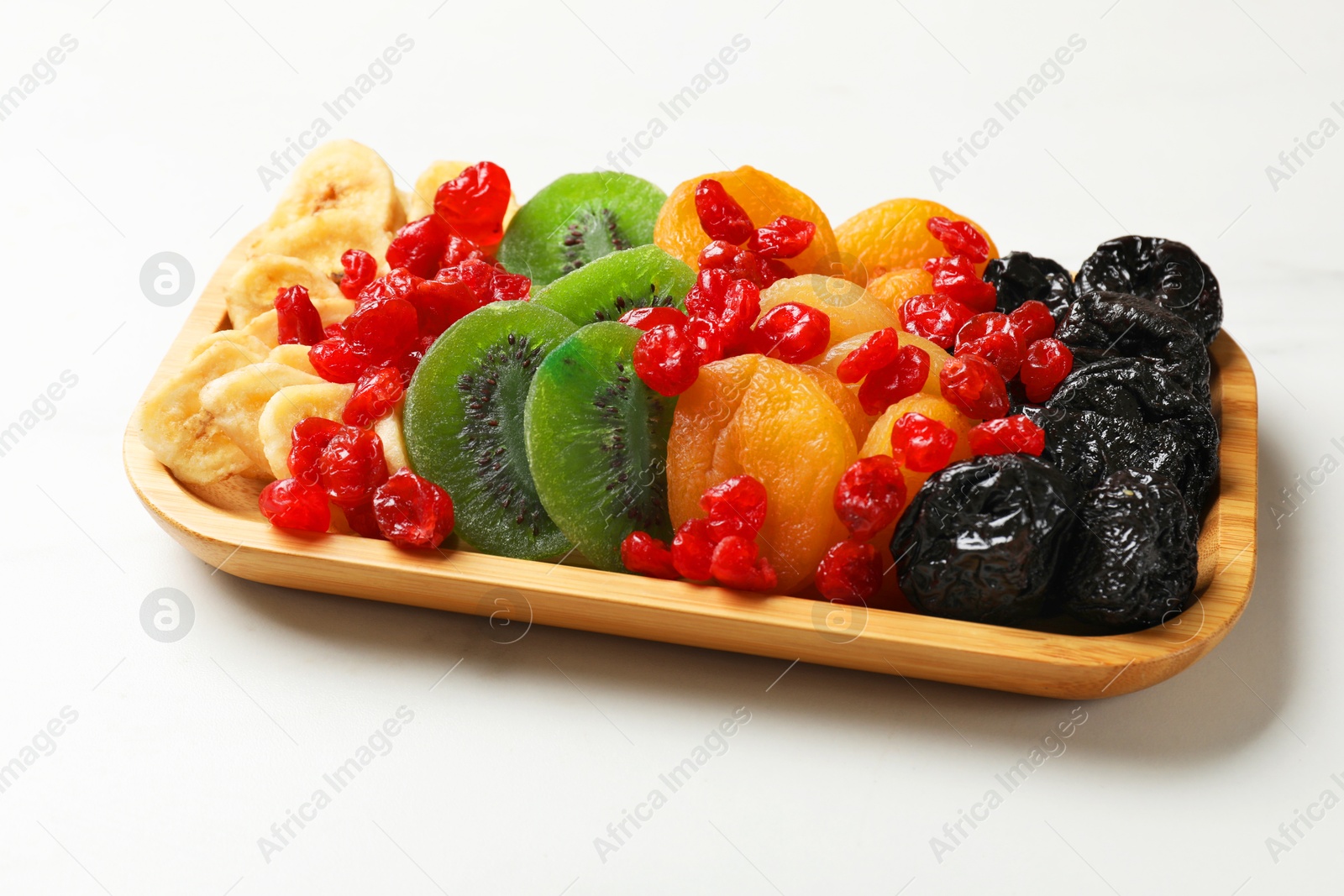 Photo of Different dried fruits on white table, closeup