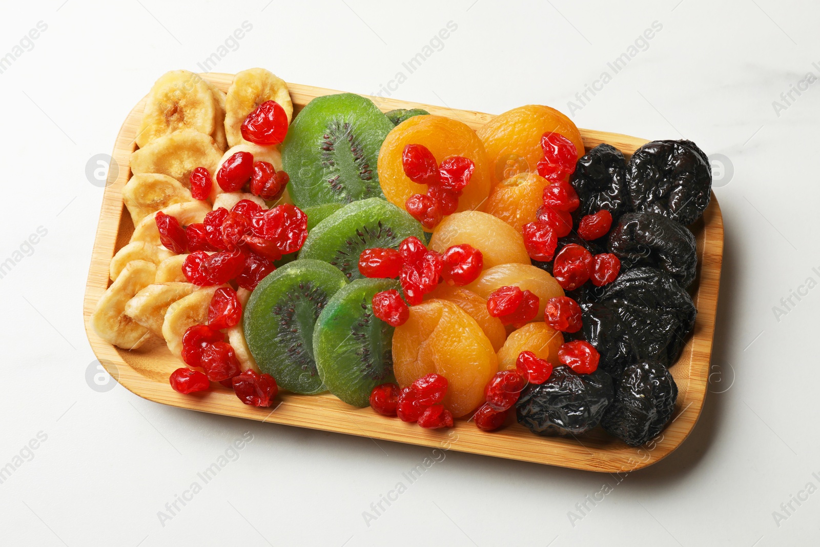 Photo of Different dried fruits on white table, closeup