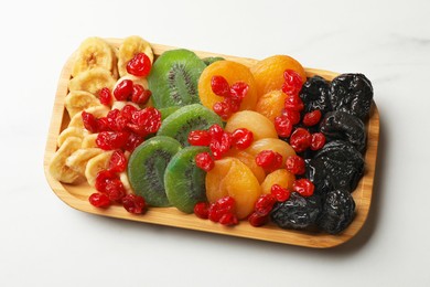 Photo of Different dried fruits on white table, closeup