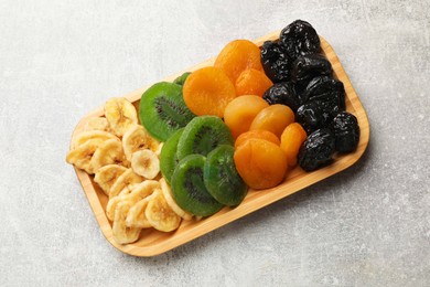 Photo of Different dried fruits on grey table, top view