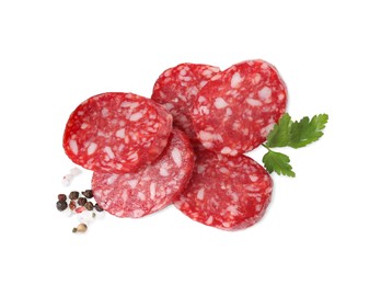 Pieces of delicious dry cured sausage and spices isolated on white, top view