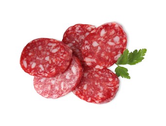 Pieces of delicious dry cured sausage and parsley isolated on white, top view